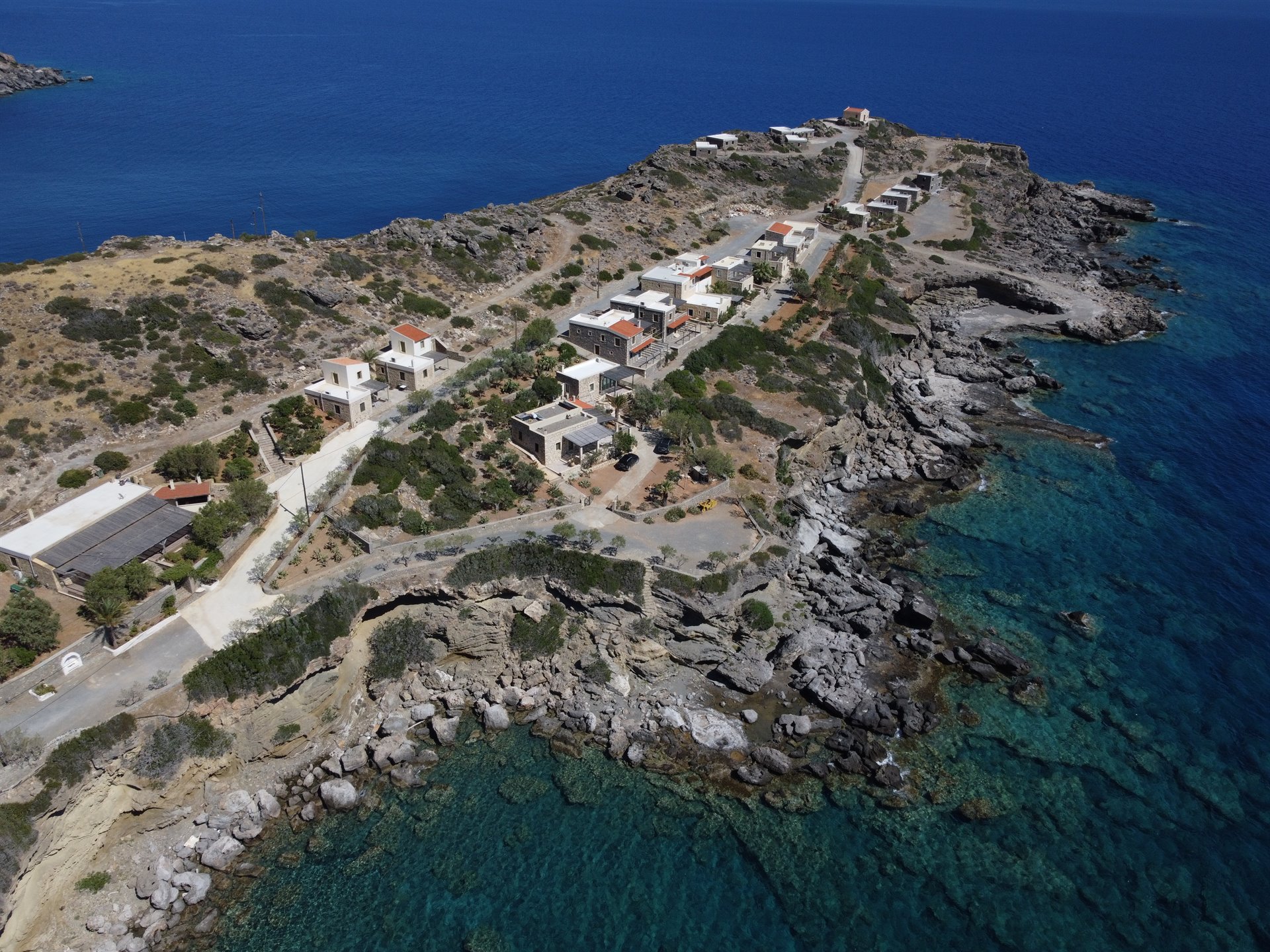 Aerial view of Cavo Ponta stone houses on the rocky South Cretan coast
