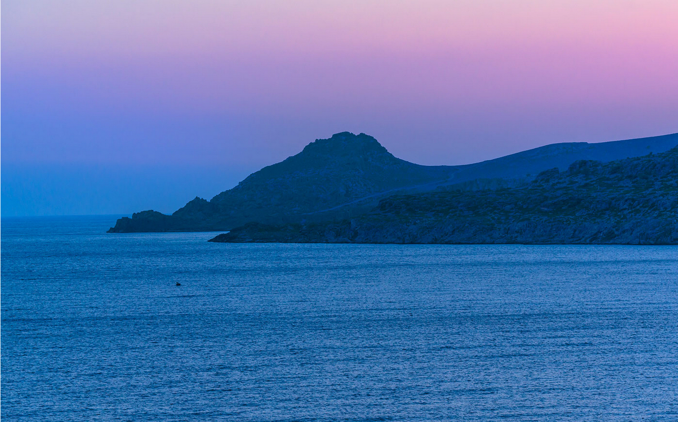 Evening view across Agios Ioannis bay and the Asterousia slopes