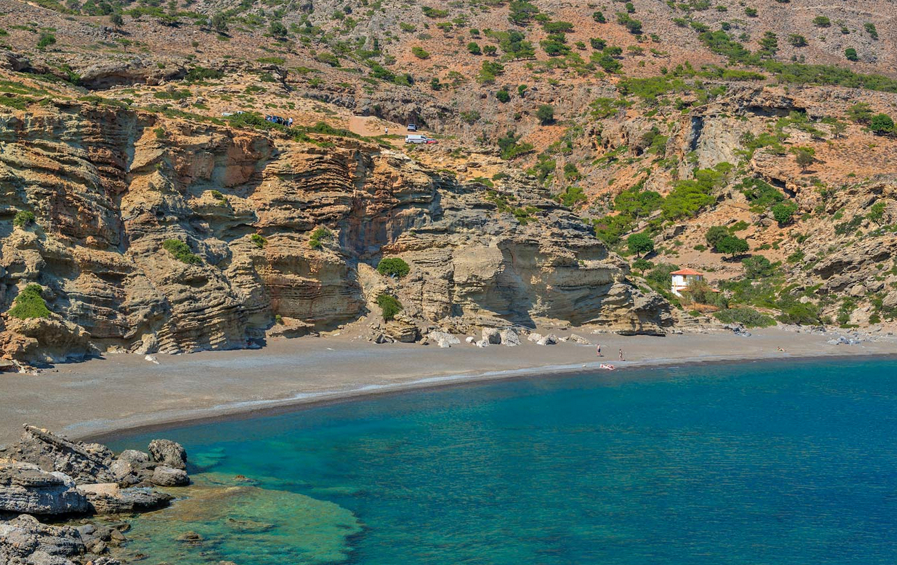 Quiet beach and layered cliffs along the South Cretan coastline near Cavo Ponta
